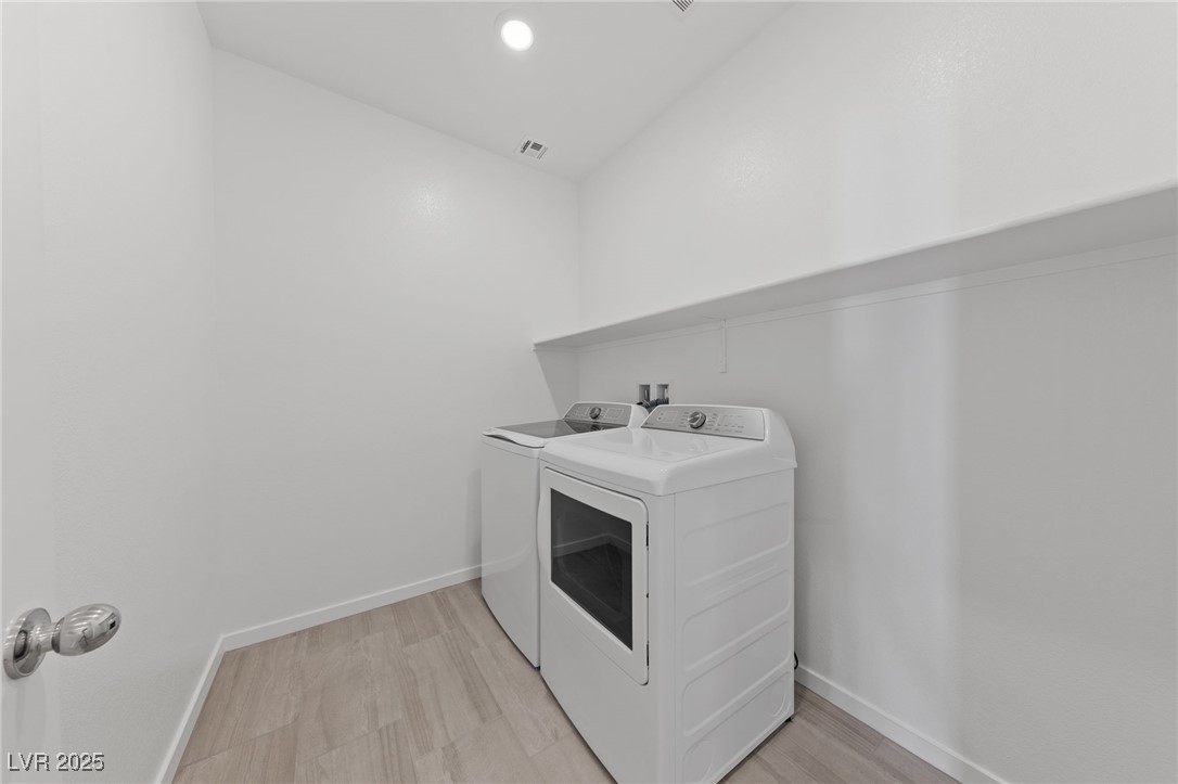 1561 Layla Crossing Avenue Henderson, NV 89002 - Photo 17 of 31 Laundry area featuring light wood-style floors, independent washer and dryer, and recessed lighting