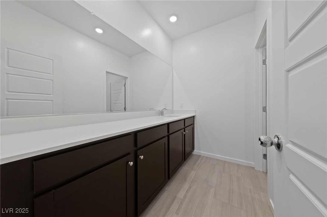 1561 Layla Crossing Avenue Henderson, NV 89002 - Photo 18 of 31 Bathroom featuring vanity, recessed lighting, and light wood-style flooring