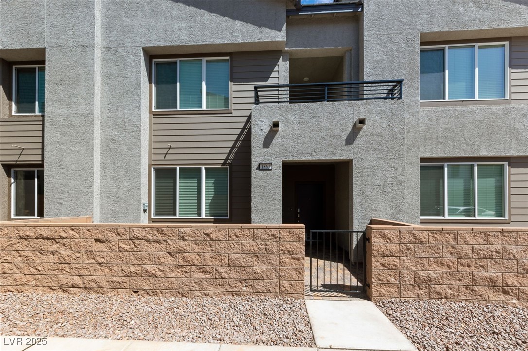 1561 Layla Crossing Avenue Henderson, NV 89002 - Photo 2 of 31 Property entrance with stucco siding and a gate