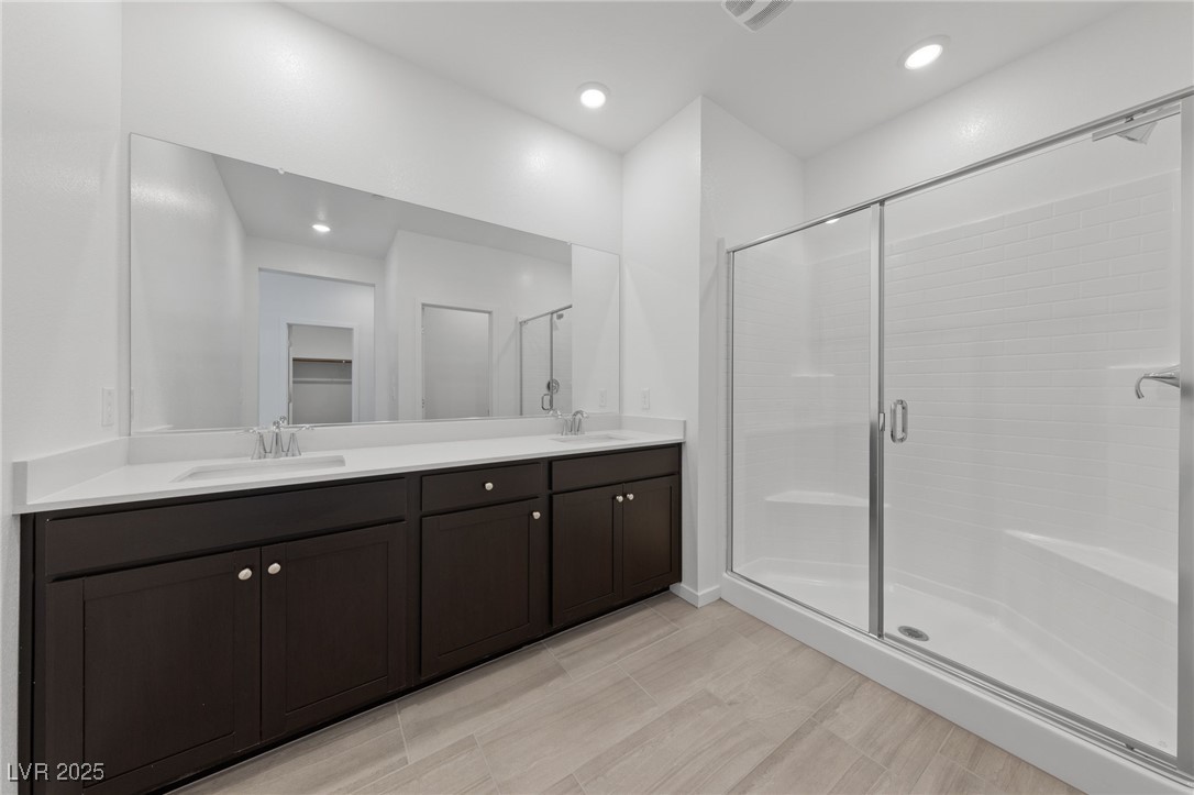 1561 Layla Crossing Avenue Henderson, NV 89002 - Photo 19 of 31 Full bath with a stall shower, double vanity, and recessed lighting