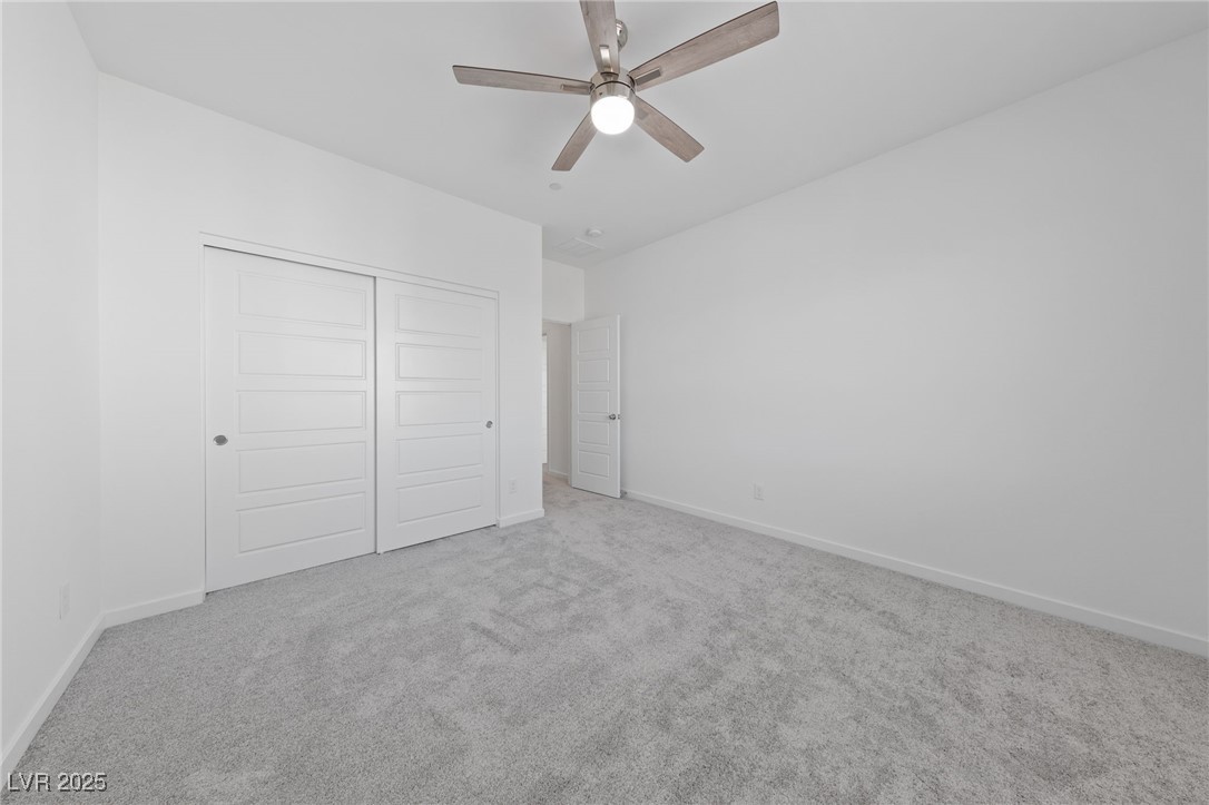 1561 Layla Crossing Avenue Henderson, NV 89002 - Photo 23 of 31 Unfurnished bedroom with carpet flooring, a closet, and ceiling fan