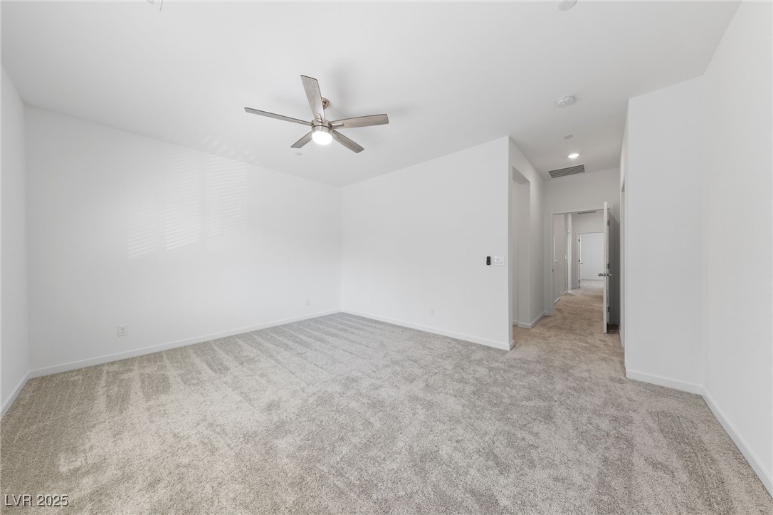 1561 Layla Crossing Avenue Henderson, NV 89002 - Photo 24 of 31 Unfurnished room featuring light colored carpet and a ceiling fan