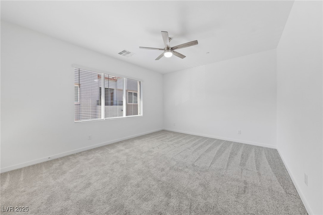 1561 Layla Crossing Avenue Henderson, NV 89002 - Photo 26 of 31 Spare room featuring light colored carpet and ceiling fan