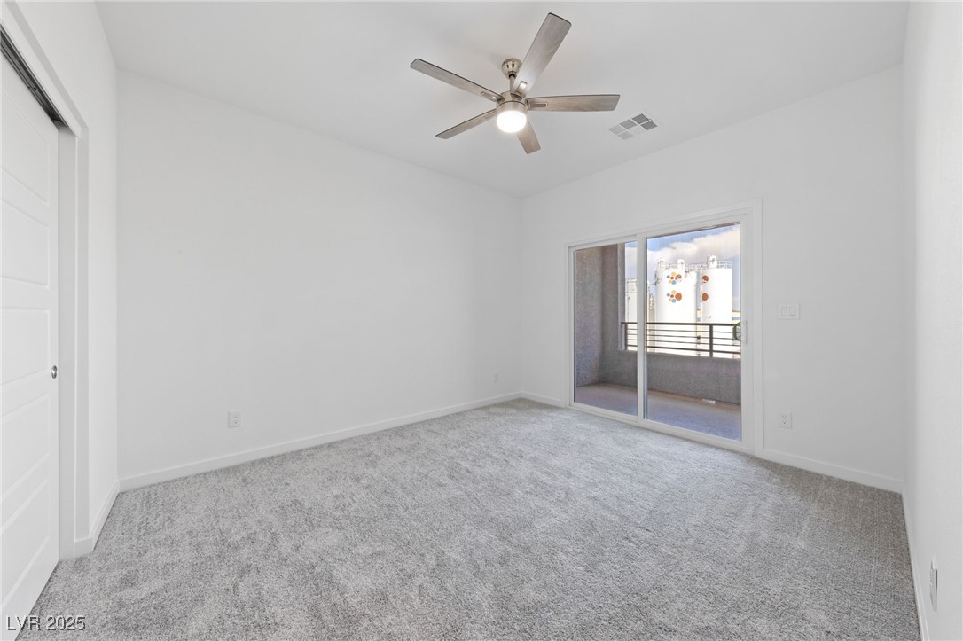 1561 Layla Crossing Avenue Henderson, NV 89002 - Photo 27 of 31 Unfurnished bedroom with access to exterior, carpet, a ceiling fan, and a closet