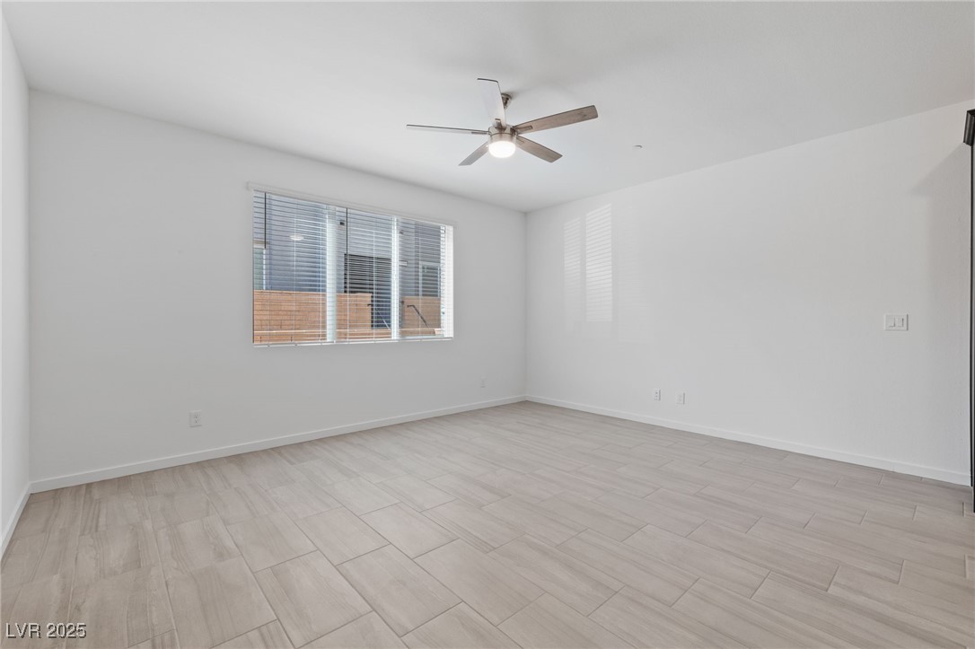 1561 Layla Crossing Avenue Henderson, NV 89002 - Photo 5 of 31 Spare room with wood finish floors and ceiling fan