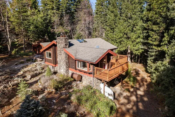 an aerial view of a house with a yard