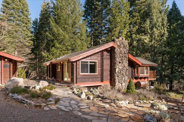 a backyard of a house with yard and outdoor seating