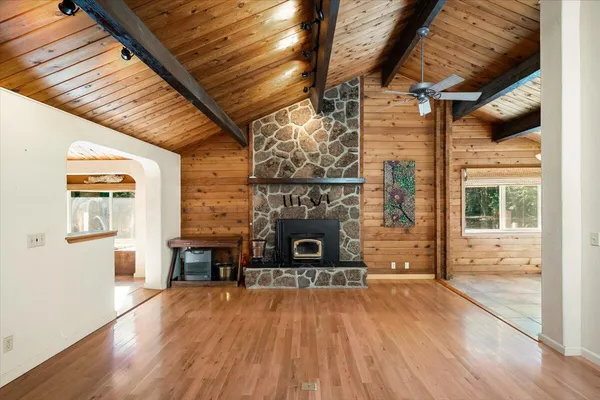 a view of a livingroom with wooden floor and a fireplace