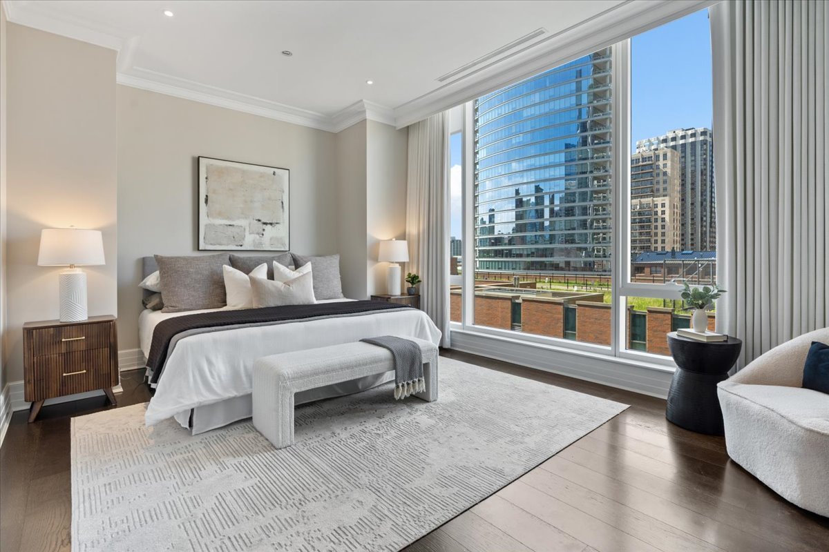 9 West Walton Street, Unit 702 Chicago, IL 60610 - Photo 19 of 38 a bedroom with a bed and glass window