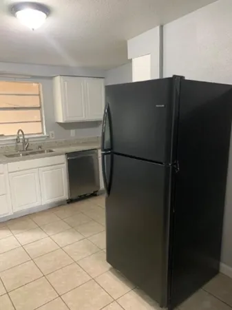 a kitchen with stainless steel appliances a refrigerator and a sink