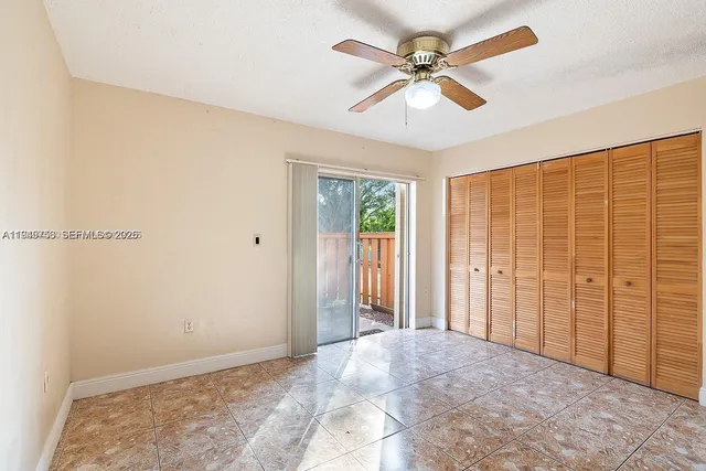 a view of a livingroom with a ceiling fan and a window