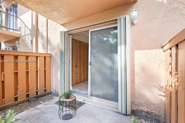 a view of a door with wooden floor and a bathroom