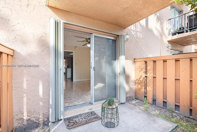 a view of a house with a backyard and trees