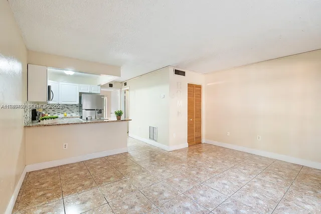a view of kitchen with stainless steel appliances cabinets and wooden floor