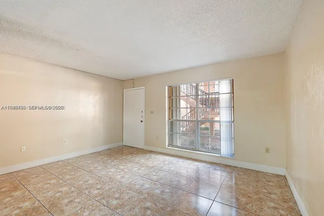 a view of an empty room with a window