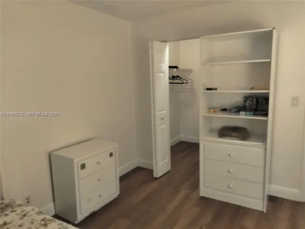 a view of walk in closet with empty racks