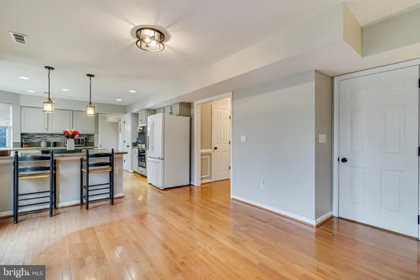 a view of kitchen with cabinets and wooden floor