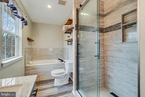 a bathroom with a shower a toilet and a shower