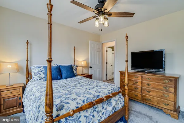 a bedroom with a large bed and a flat screen tv