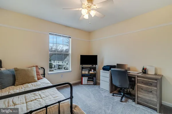 a view of a livingroom with workspace and a window