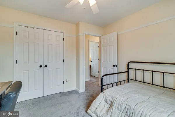 a bedroom with bed and a chandelier