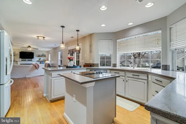 a kitchen with stainless steel appliances granite countertop a stove and more cabinets