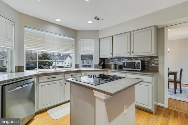 a kitchen with appliances a sink and cabinets
