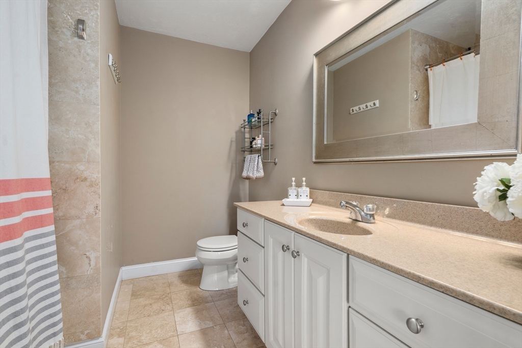 8 Brookside Lane, Unit 8 Northborough, MA 01532 - Photo 14 of 24 a bathroom with a sink and a mirror