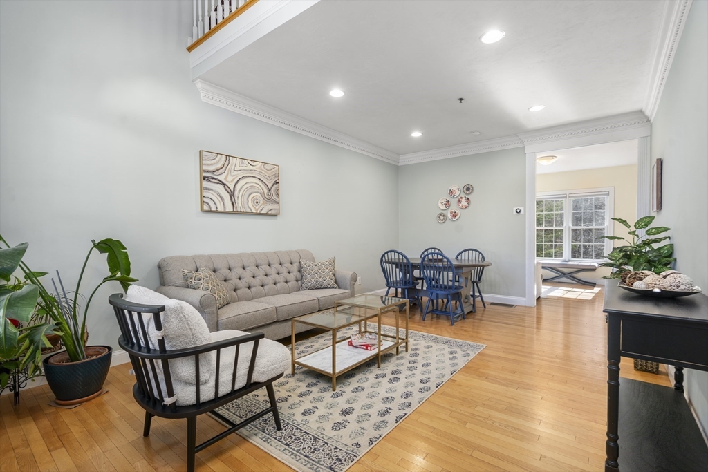 8 Brookside Lane, Unit 8 Northborough, MA 01532 - Photo 3 of 24 a living room with furniture and flowers