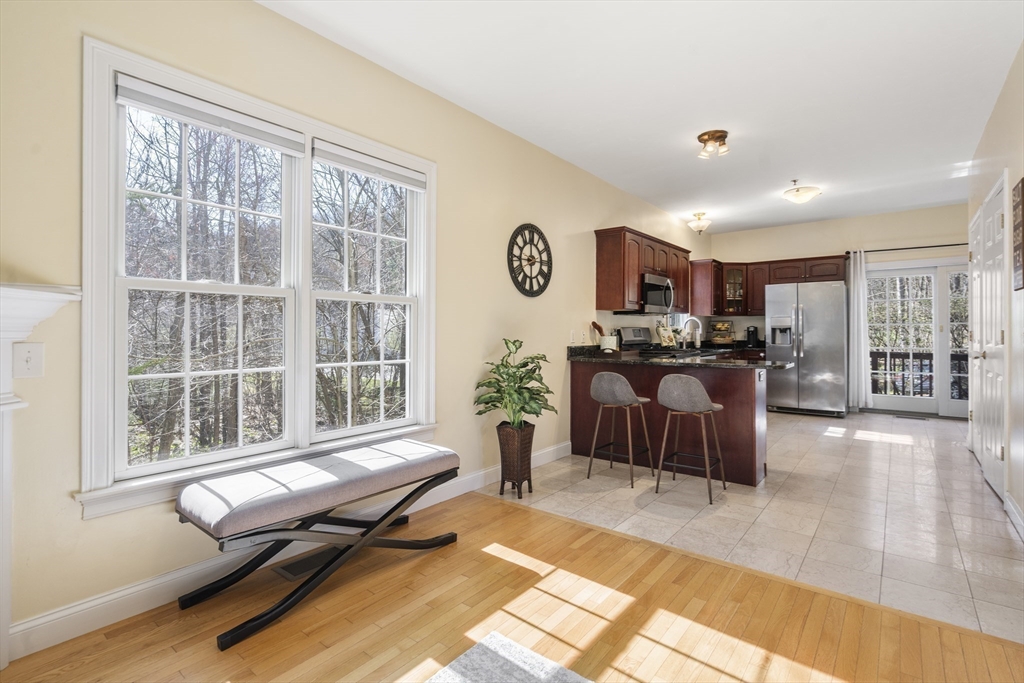 8 Brookside Lane, Unit 8 Northborough, MA 01532 - Photo 7 of 24 a living room with furniture and a large window