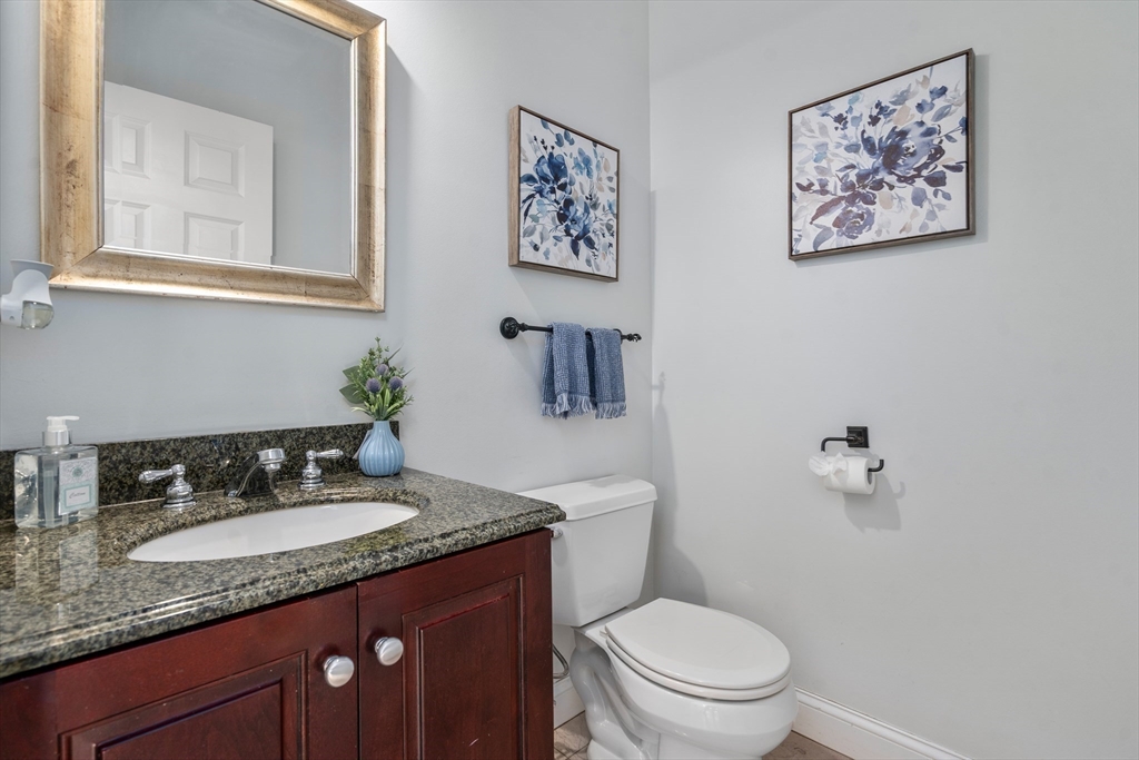 8 Brookside Lane, Unit 8 Northborough, MA 01532 - Photo 10 of 24 a bathroom with a granite countertop sink mirror vanity and toilet