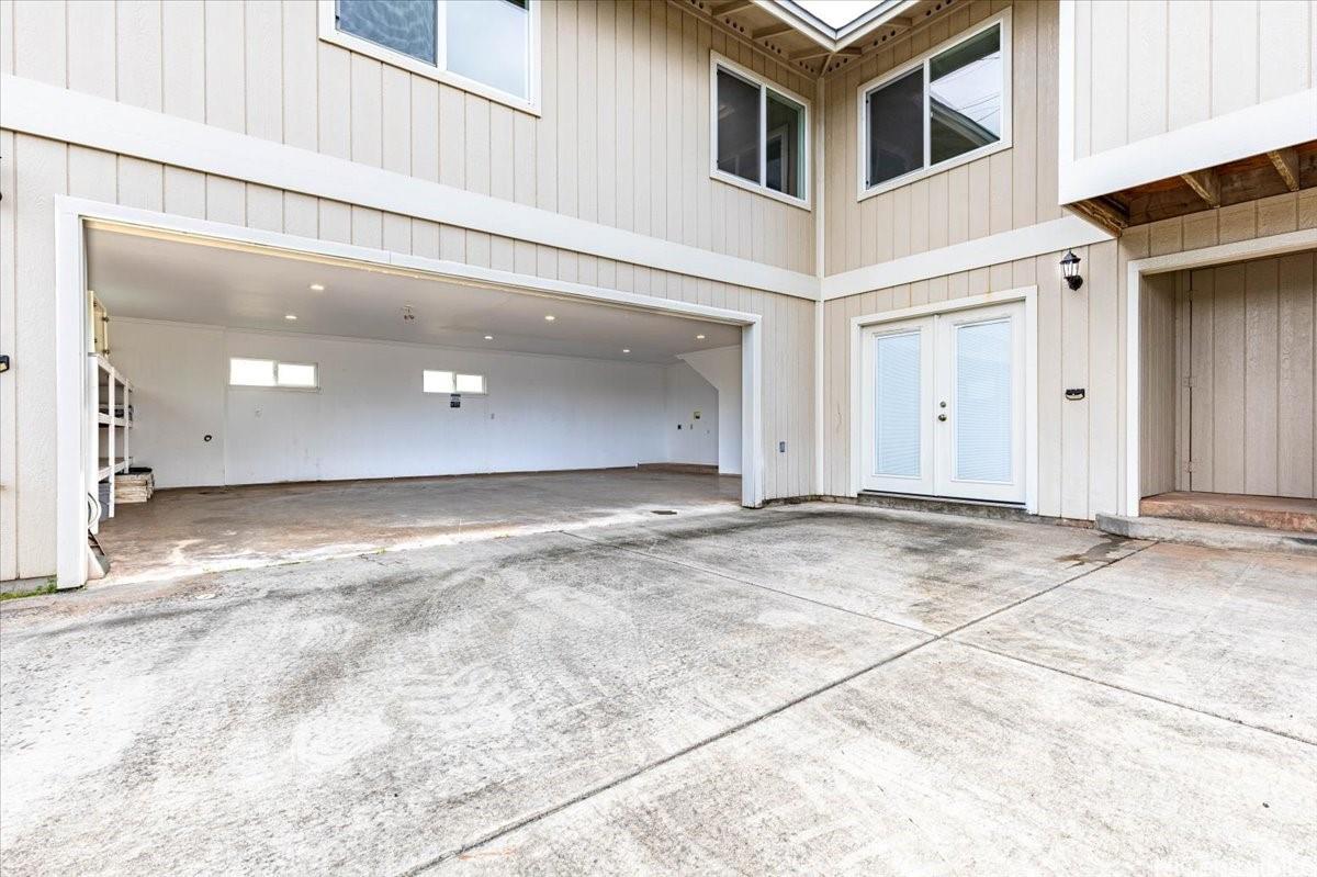 45-567 Keaahala Road, Unit A Kaneohe, HI 96744 - Photo 5 of 25 Large driveway to large open garage. Dbl doors to new side. Storage room to the right.