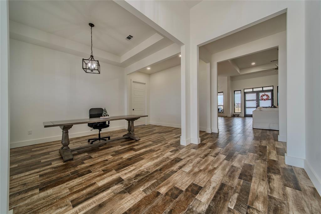165 Ranch House Road Rockwall, TX 75032 - Photo 17 of 40 a living room with a couch and a chandelier