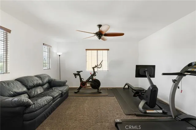 a living room with furniture a air conditioner and a window