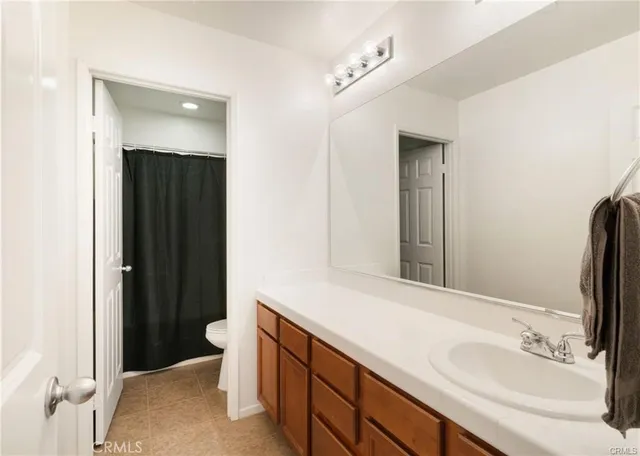 a bathroom with a double vanity sink and mirror