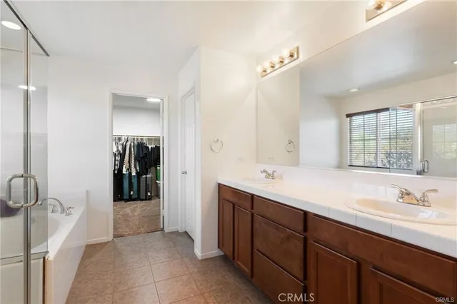 a bathroom with a double vanity sink and mirror