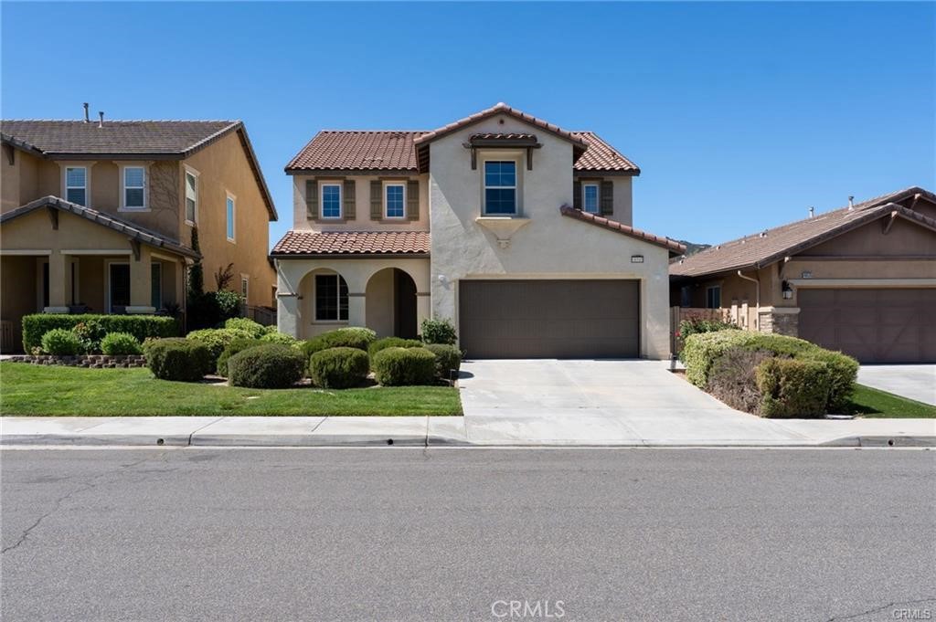 46545 Peach Tree Street Temecula, CA 92592 - Photo 2 of 30 a front view of a house with a garden and plants