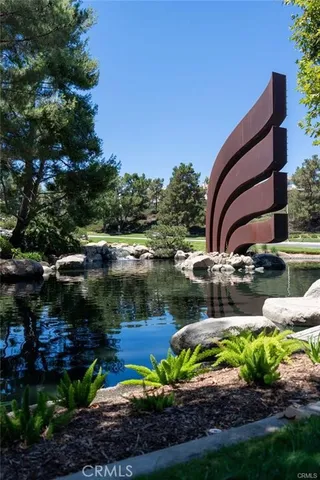 a view of a lake with a house in background