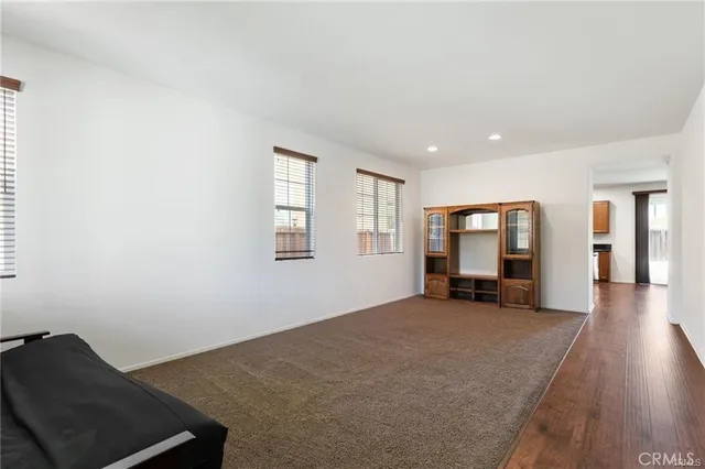 a view of a livingroom with workspace and a window