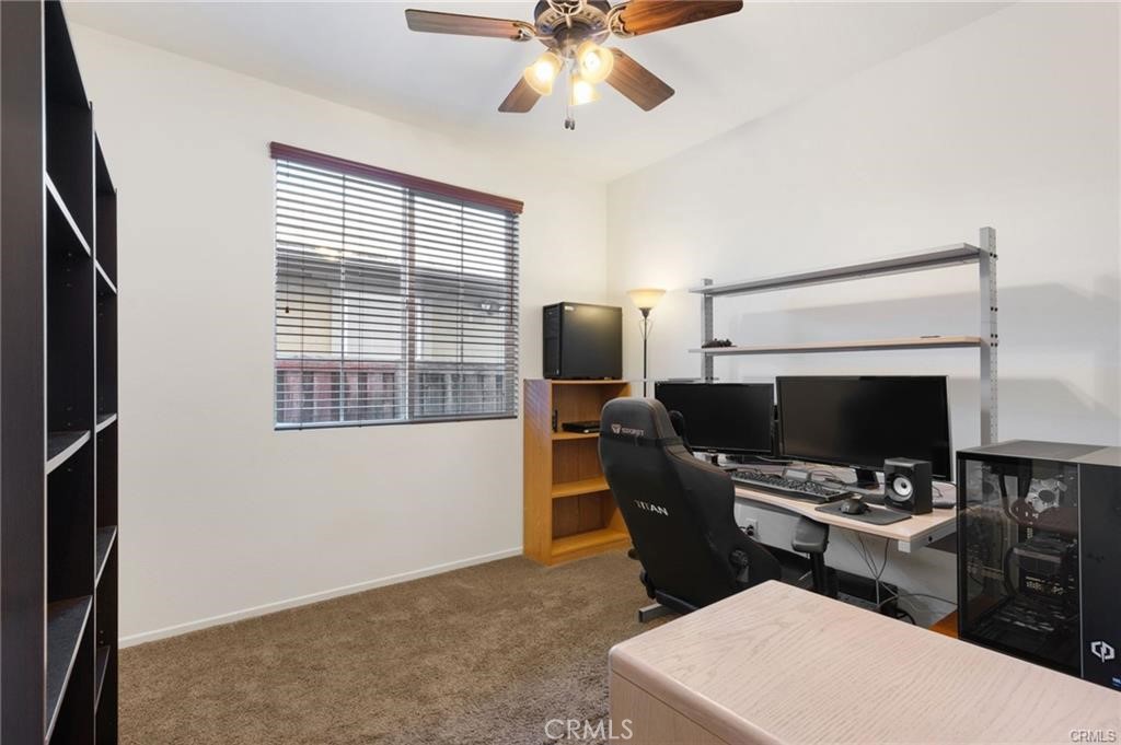 46545 Peach Tree Street Temecula, CA 92592 - Photo 9 of 30 a living room with furniture a fireplace and a flat screen tv