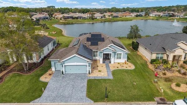 an aerial view of a house with a lake view