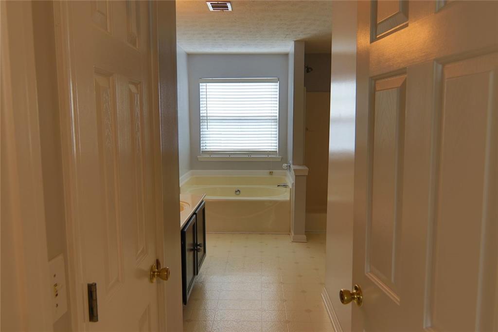363 Springhaven Way Southeast Lawrenceville, GA 30046 - Photo 11 of 13 a bathroom with a bathtub and a shower