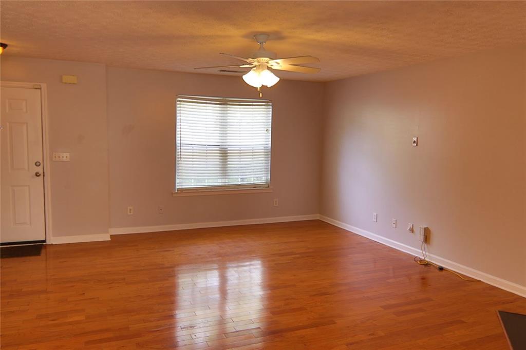 363 Springhaven Way Southeast Lawrenceville, GA 30046 - Photo 6 of 13 a view of an empty room with wooden floor and a window