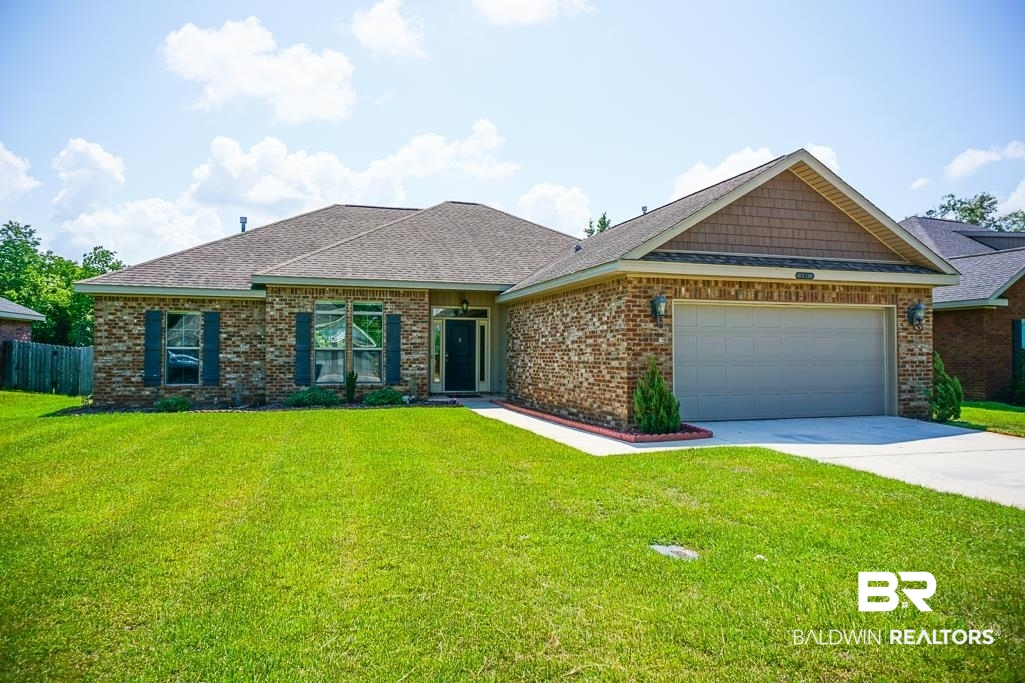 593 Begeman Road Mobile, AL 36608 - Photo 1 of 23 View of front facade featuring a garage and a front lawn