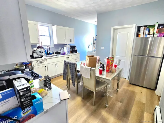 a view of a dining room with furniture and a window