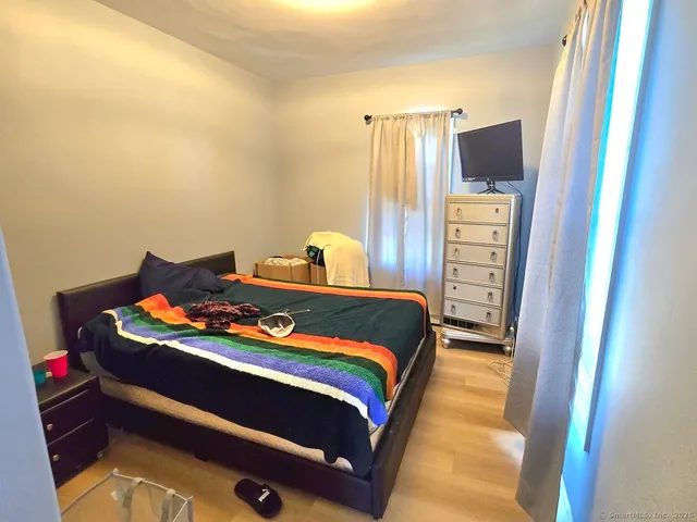 a bedroom with a bed and flat screen tv