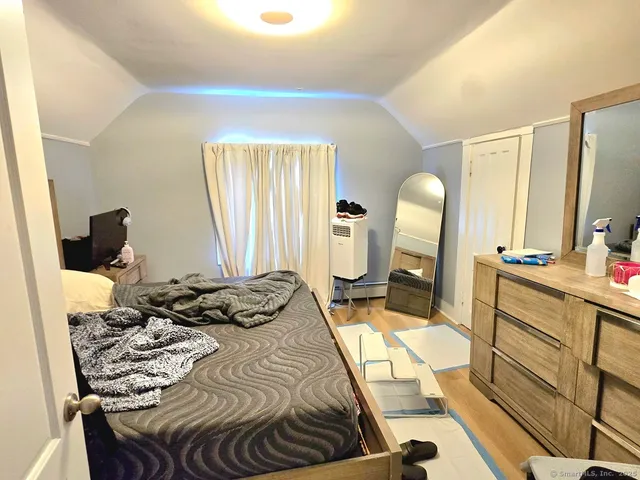 a bed room with a bed and a mirror