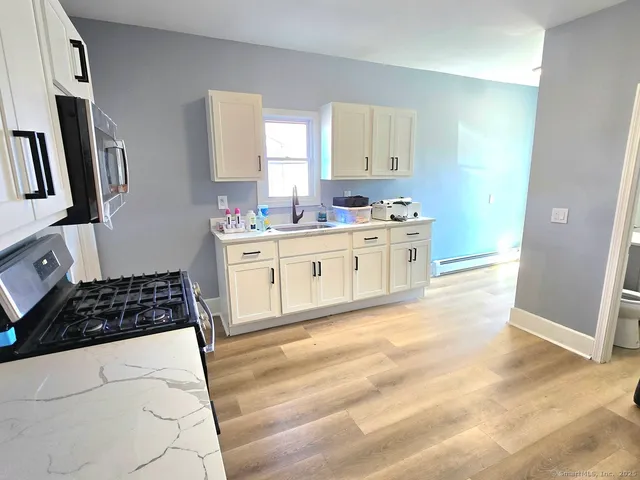 a kitchen with a stove a sink and a refrigerator