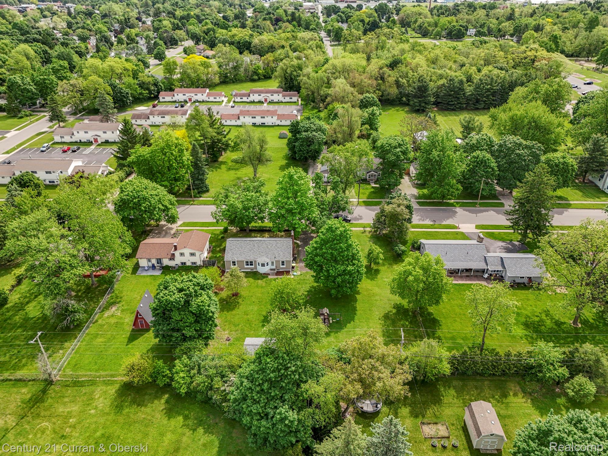 411 South Adrian Street Tecumseh, MI 49286 - Photo 53 of 61 Aerial perspective of suburban area featuring a tree filled landscape