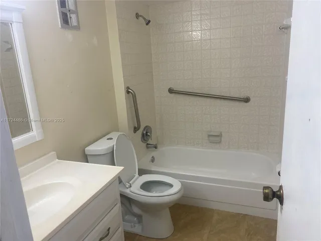 a bathroom with a toilet a sink and bathtub